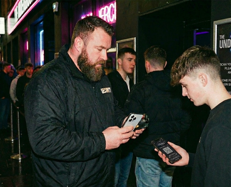 Bouncer scanning a ticket at the door